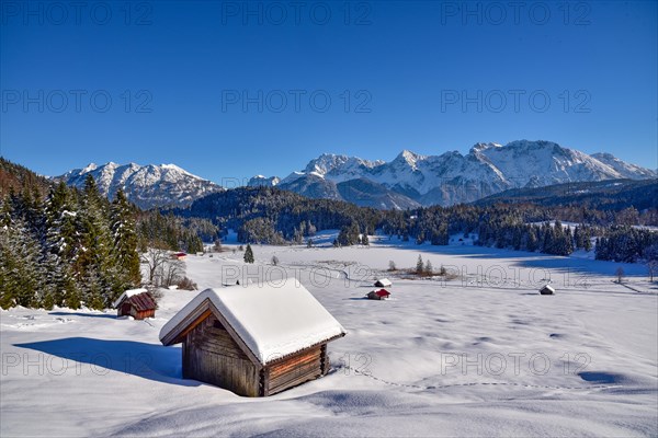View of the frozen and snow-covered Geroldsee lake in Werdenfelser Land near Garmisch, with the Karwendel mountains in the background, Bavaria, Germany, Europe
