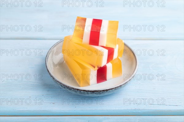 Almond milk and peach jelly on blue wooden background. side view, close up