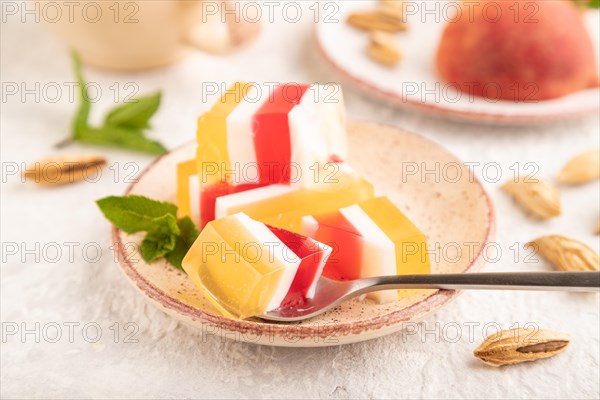 Almond milk and peach jelly on gray concrete background. side view, close up, selective focus