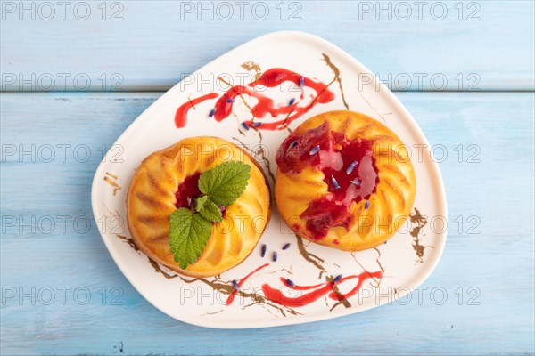 Semolina cheesecake with strawberry jam, lavender, on blue wooden background. top view, flat lay, close up