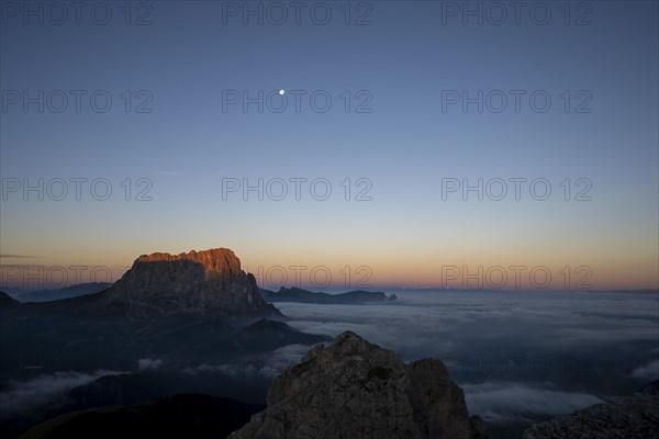 Sunrise over a sea of fog with the peaks of the Sella massif in the background, Corvara, Dolomites, Italy, Europe
