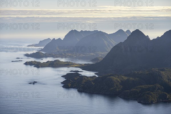 View of the coast in Ulvagsundet fjord and mountains in the evening light, view from the summit of Dronningsvarden or Stortinden, Vesteralen, Norway, Europe