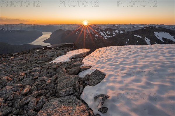 View of mountains and fjord Faleidfjorden, sun star at sunset, summit of Skala, Loen, Norway, Europe