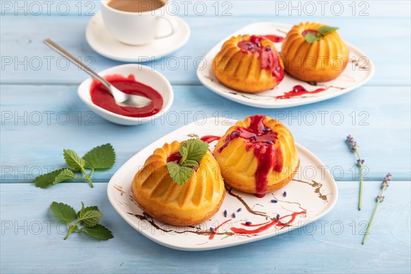 Semolina cheesecake with strawberry jam, lavender, cup of coffee on blue wooden background. side view, close up