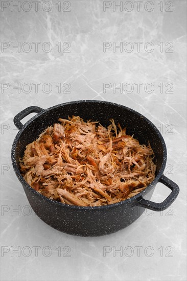 Baked in oven pulled pork in a large pot