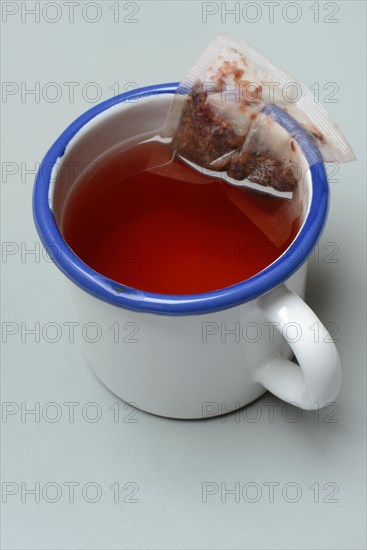 Red fruit tea in mug with tea bag, tea