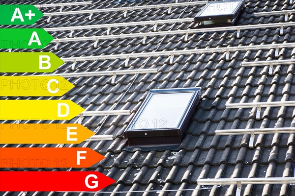 Mounted brackets for solar panels on the roof of a house, graphic with energy efficiency classes for buildings according to the GEG, Duesseldorf, Germany, energy efficiency, Europe