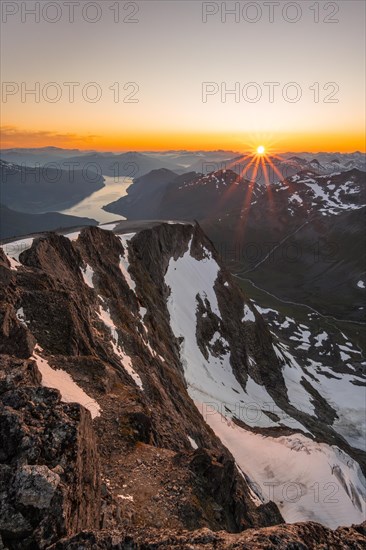 View of mountains and fjord Faleidfjorden, sun star at sunset, summit of Skala, Loen, Norway, Europe