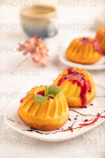 Semolina cheesecake with strawberry jam, lavender, cup of coffee on gray concrete background and linen textile. side view, close up, selective focus