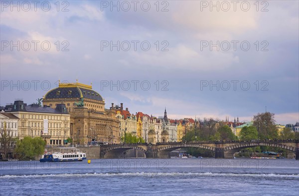 Beautiful National Theatre building and Vltava river in the city center of Prague, Czech Republic (Czechia), at sunset