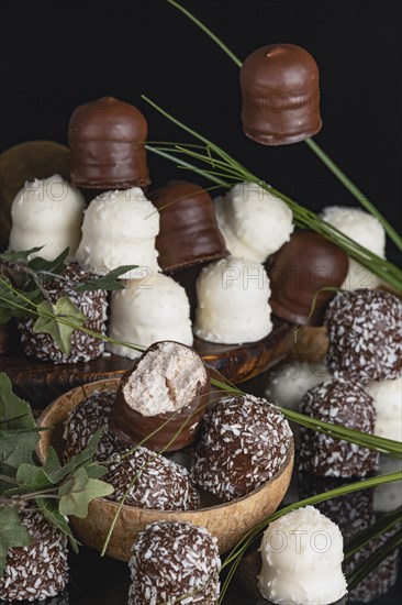 Chocolate kisses arranged decoratively on a wooden board and in a coconut half