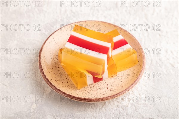 Almond milk and peach jelly on gray concrete background. side view, close up