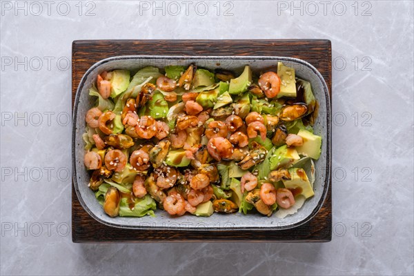 Top view of salad with shrimp, mussels and avocado