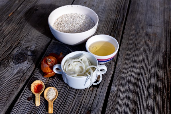 Raw Ingredient to Make the Saffron Rice, Risotto alla Milanese with Parmesan Cheese and White Wine and Onion on an Old Wood Table with Sunlight in Lugano, Ticino, Switzerland, Europe