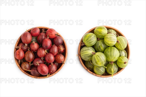 Fresh red and green gooseberry in clay bowl isolated on white background. top view, flat lay, close up
