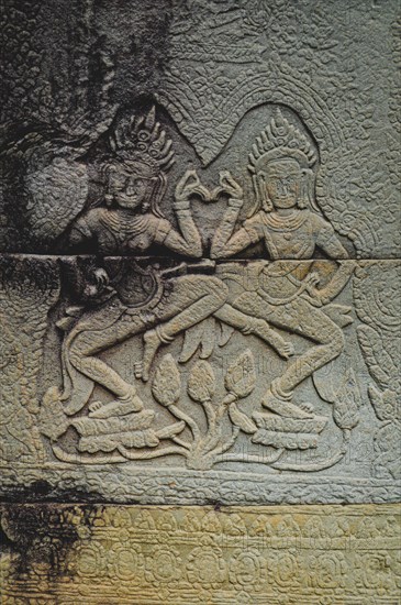 Bas-relief of Apsaras, celestial dancers from Hindu mythology, carved in stone in Khmer style. Angkor Wat. Siem reap, Cambodia, Asia