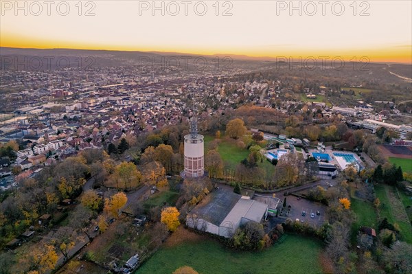 Cityscape with a water tower in the foreground during an autumn sunset, Pforzheim, Germany, Europe