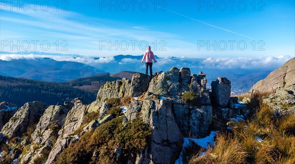 A man reaching the top of the mountain while trekking