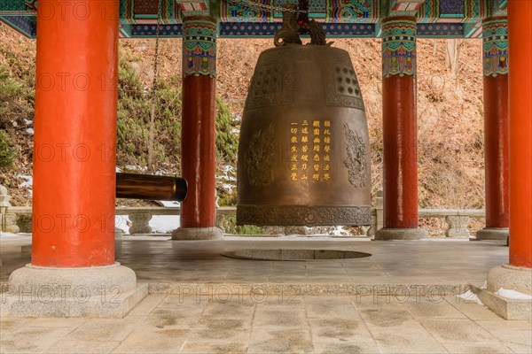Giant brass bell in colorful pavilion at Guinsa temple in South Korea