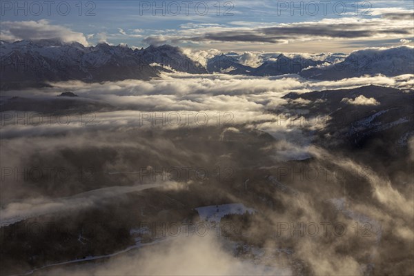 Mountain peaks rise above high fog in the evening light, winter, snow, view from Herzogstand to Karwendel Mountains, Bavarian Alps, Upper Bavaria, Bavaria, Germany, Europe