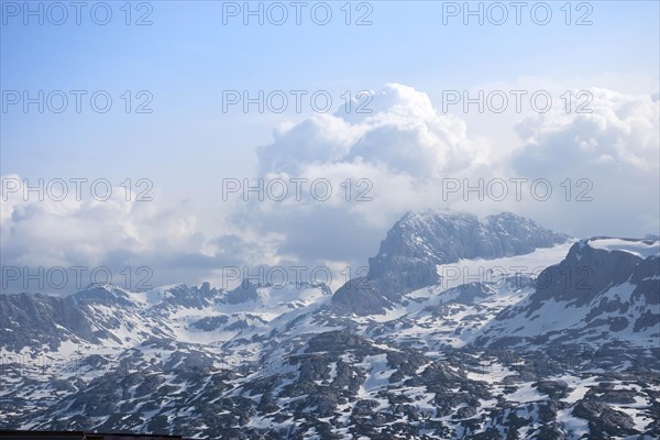 Amazing mountains panorama from 5 Fingers viewing platform in the shape of a hand with five fingers on Mount Krippenstein in the Dachstein Mountains of Upper Austria, Salzkammergut region, Austria, Europe