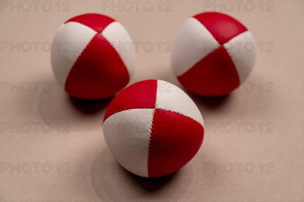 Three juggling balls in front of a light background, selective focus, studio shot, Germany, Europe