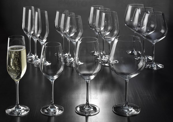 Wine glasses, champagne goblets, a filled champagne goblet