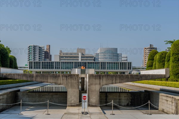 Peace Fire at Memorial Park with city buildings in background in Hiroshima, Japan, Asia