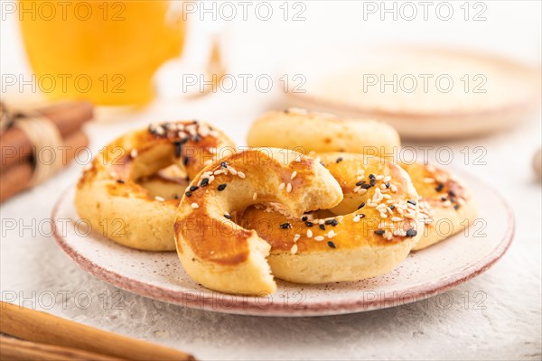 Homemade asian salted cookies, cup of green tea on gray concrete background and linen textile. side view, selective focus