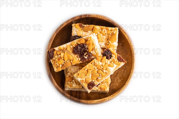 Traditional candy nougat with nuts and sesame isolated on white background. top view, flat lay, close up