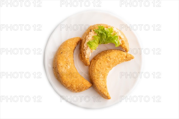 Homemade salted crescent-shaped cheese cookies isolated on white background. top view, flat lay