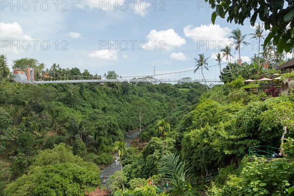 Bridge near Tegenungan waterfall, Bali island, Ubud, Indonesia. Jungle, tropical forest, daytime with cloudy sky