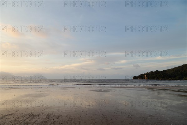 Bako national park, sea sandy beach, overcast, cloudy sunset, sky and sea, low tide. Vacation, travel, tropics concept, no people, Malaysia, Kuching, Asia