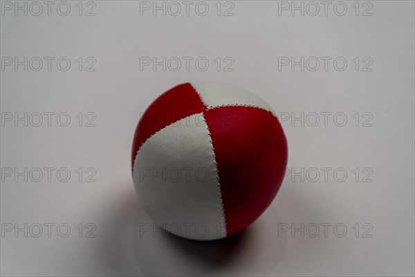 Juggling ball in front of a white background, studio shot, Germany, Europe