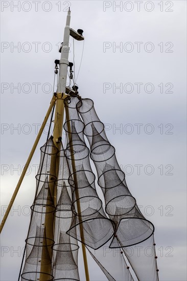 Fish traps hanging to dry on a ship's mast, Oudeschild, North Sea island, Texel, West Frisian Island, North Holland, Netherlands