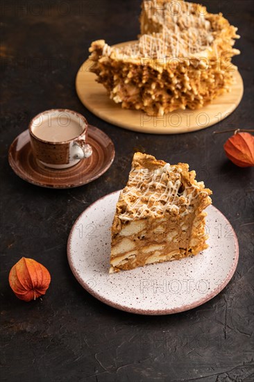 Traditional lithuanian cake shakotis with cup of coffee on black concrete background. side view, close up