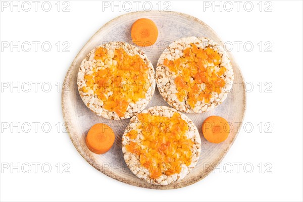 Carrot jam with puffed rice cakes isolated on white background. Top view, flat lay, close up