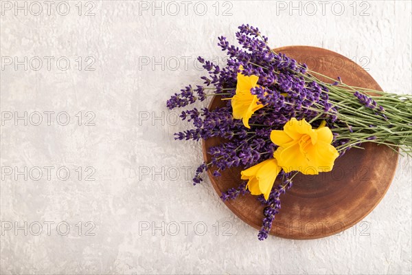 Beautiful day lily and lavender flowers on gray concrete background, flat lay, top view, copy space