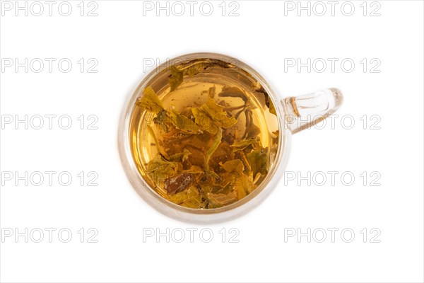 Red tea with herbs in glass cup isolated on white background. Healthy drink concept. Top view, flat lay, close up