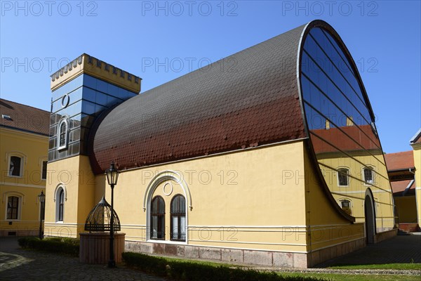 An unusual combination of modern glass architecture and traditional building elements under a clear blue sky, officers' palace, church, Komarno, Komarom, Komorn, Nitriansky kraj, Slovakia, Europe