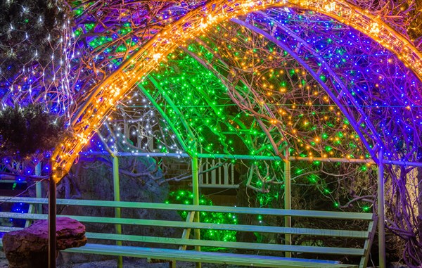 Colorful Christmas lights on metal awning over park bench in South Korea