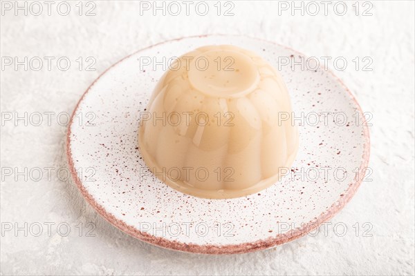 Buckwheat milk jelly on gray concrete background. side view, close up