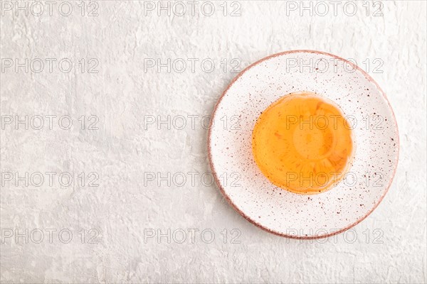Papaya and orange jelly on gray concrete background. top view, flat lay, copy space