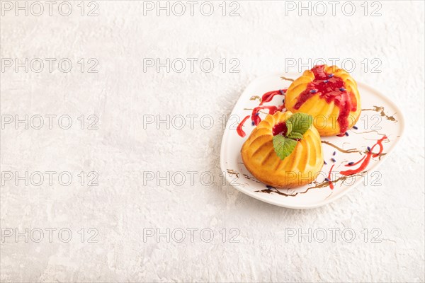 Semolina cheesecake with strawberry jam, lavender on gray concrete background. side view, copy space