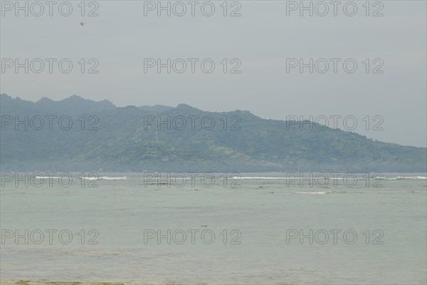 Lombok and Gili Air islands, overcast, cloudy day, sky and sea. Vacation, travel, tropics concept, no people. Sunny day, sand beach