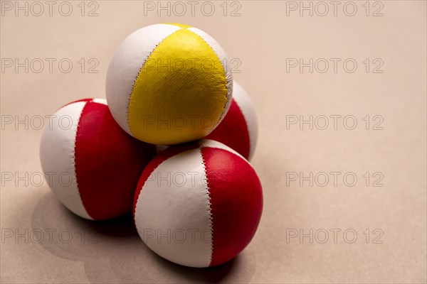 Three juggling balls in front of a light background, selective focus, studio shot, Germany, Europe