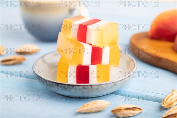 Almond milk and peach jelly on blue wooden background. side view, close up, selective focus