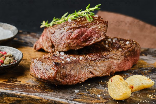 Closeup view of uncut beef strip steak on cutting board