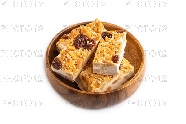 Traditional candy nougat with nuts and sesame isolated on white background. side view, close up