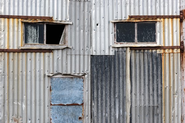 Corrugated iron panelling and windows, abandoned herring factory Djupavik, Reykjarfjoerour, Strandir, Arnes, Westfjords, Iceland, Europe